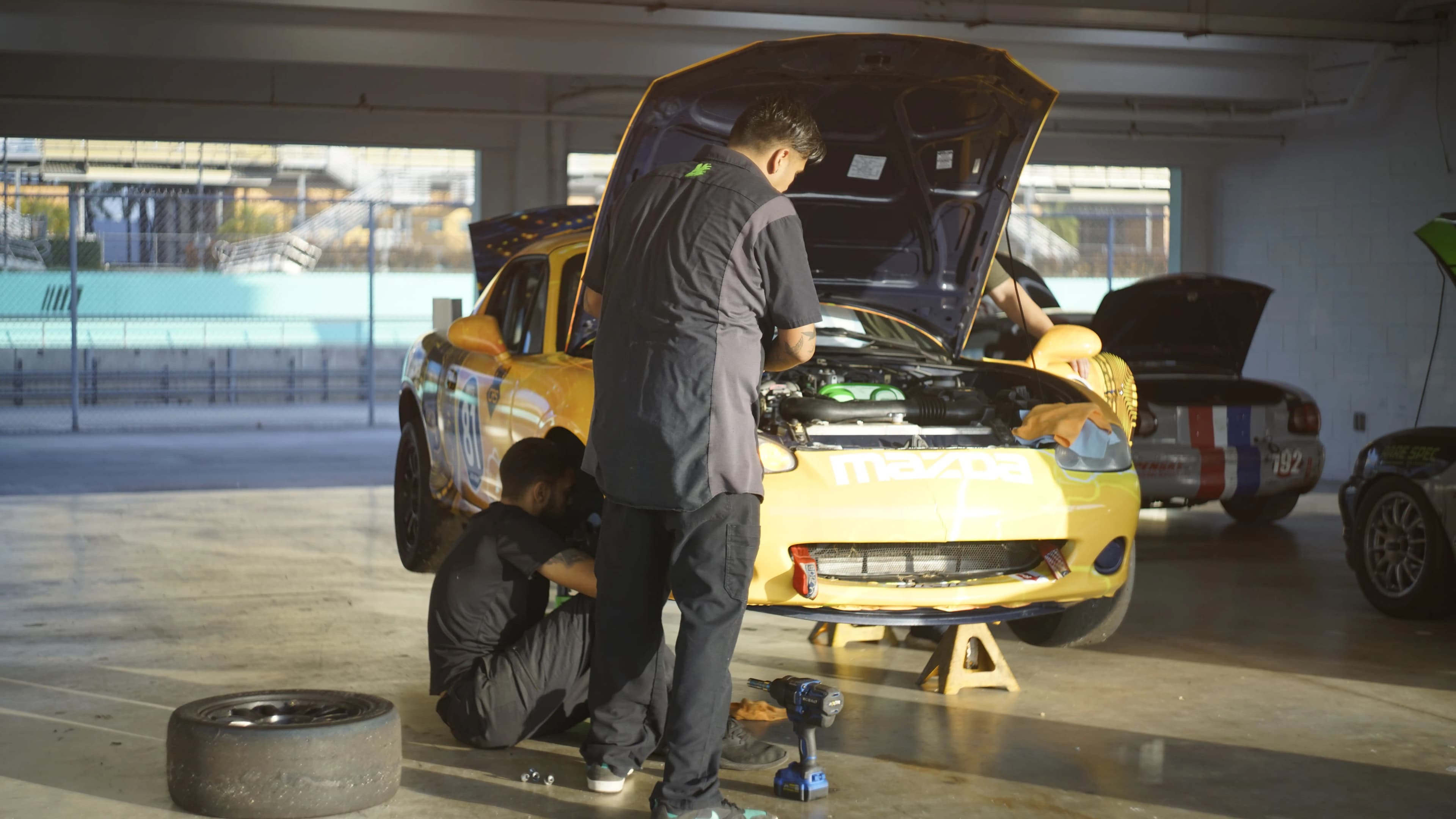 Bitcoin Racing crew working on car in garage